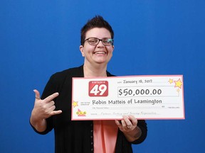 Robin Matteis of Leamington and her $50,000 prize cheque from an Ontario 49 draw.