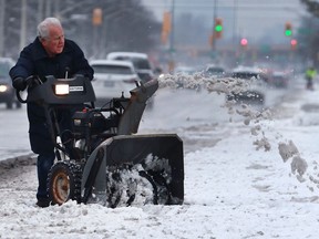 Gunther Wolf gives his  snowblower a workout while clearing the sidewalks in front of his Dougall Avenue home on Tuesday, January 31, 2017 in Windsor.