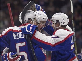 Windsor Spitfires Austin McEneny, left, Connor Corcoran and Kyle Auger celebrate after a goal in the second period against the Guelph Storm in OHL action at the WFCU Centre on Jan. 22, 2017.