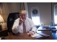 U.S. President Donald Trump poses in his office aboard Air Force One at Andrews Air Force Base on Jan. 26, 2017.