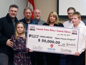 Unifor Local 444 presented a $50,000 cheque to the Canadian Mental Health Association Windsor/Essex County Branch for the Sole Focus Project on Jan. 24, 2017 in memory of Charlie Brooks. Local 444 president Dino Chiodo, left, and Claudia den Boer, CEO, CMHA-WECB, right, pose with members of the Charlie Brooks family during the event.