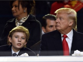 U.S. President Donald Trump and his son Barron attend the presidential inaugural parade on Jan. 20, 2017 in Washington, D.C.