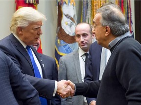 U.S. President Donald Trump, left, greets Fiat Chrysler CEO Sergio Marchionne prior to a meeting with automobile industry leaders in the Roosevelt Room of the White House in Washington, D.C., Jan. 24, 2017.