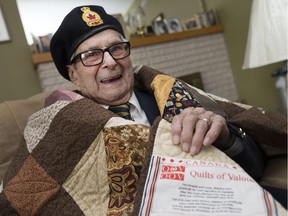 Second World War Navy veteran, Vermont "Monty" Ionson receives a Quilt of Valour at his home in LaSalle, Saturday, Jan. 21, 2017.