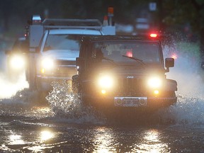 Vehicles pass through a section of Jefferson Boulevard that was flooded on Sept. 29, 2016, in Windsor.