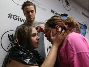 Andrew Dube shaves the head of Tabitha Wegner as she talks to her daughter Nevaeh Wegner at Transition to Betterness in Windsor on Jan. 17, 2017. Transition to Betterness hosted an Empowerment Party for Wegner during which she shaved her head. Wegner, who has terminal cancer, starts chemotherapy on Wednesday.