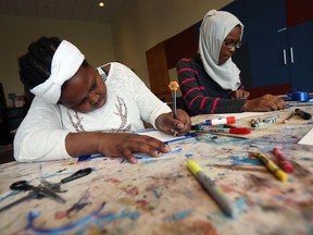 Students Aseil Hamdan, left, and Lamiya Naowal from Marlborough school create personal art projects during an educational trip to the Art Gallery of Windsor in Windsor on Jan. 18, 2017. Thanks to donation from the Tepperman family, 20 Grade 5 classes will be able to take part in the program.