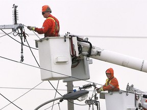 Enwin Utility technicians work on a powerlines along the Ojibway Parkway in March 2007.
