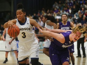 University of Windsor's Kayah Clarke, left, beats Western University's Mackenzie Puklicz to the ball during first-half OUA  action at the St. Denis Centre in Windsor on Jan. 11, 2017. The Lancer women won 70-48.