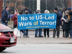 Windsor Peace Coalition hold a protest at Jackson Park on Jan. 20, 2017. The group moved up its weekly protest by one day, due to the Trump inauguration ceremony in Washington.