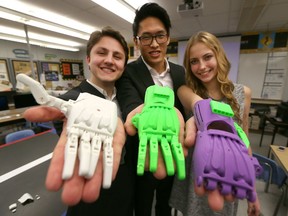 Holy Names high school students Reid Zaffino, from left, Inho Choi and Katherine St. Croix display samples of prosthetic hands that were designed for a child in India on Jan. 20, 2017.