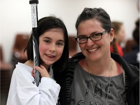 First-time hockey player Rylee Meloche, 7, with her mother Jennine Meloche after being fitted with a full set of hockey equipment during the First Shift program on Jan. 24, 2017.