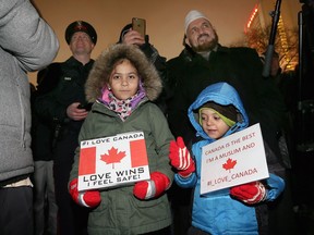 Celena Hussein, left, and her brother Rayyan Hassein participate in a candlelight vigil on Jan. 31, 2017 for those who died at a Quebec City mosque.