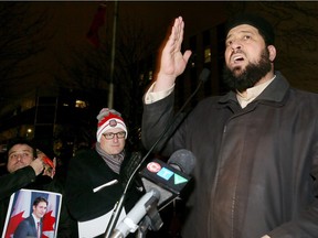 Mohamed Mohamed speaks during a candlelight vigil for those who died at a Quebec City mosque.  A large crowd of about 300 braved the bone-chilling wind January 31, 2017.