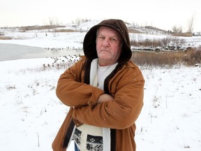 Ralph Collins stands near Blue Heron Pond in East Riverside Jan. 31, 2016.