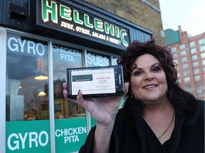 Downtown Windsor BIA executive director Debi Croucher shows a coupon on her smartphone using the DWBIA's new student coupon program. More than 40 downtown businesses - including Hellenic Sub (368 University Ave. W.) - are participating in the program, which offers discounts to university and college students.