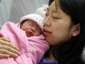 Junxuan Zhao holds her newborn daughter at Windsor Regional Hospital's Met Campus on Jan. 1, 2017. Zhao and her husband Dacheng Wei welcomed the first baby of the new year.