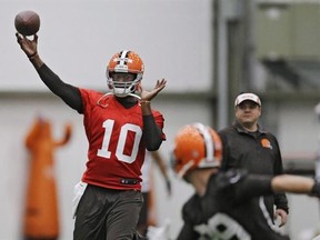 In this April 29, 2014, file photo, then-Cleveland Browns quarterback Vince Young throws during a voluntary minicamp workout at the team&#039;s NFL football training facility in Berea, Ohio. The agent representing former NFL quarterback Vince Young says he&#039;s talking to the Saskatchewan Roughriders about his client playing in the CFL. THE CANADIAN PRESS/AP/Mark Duncan