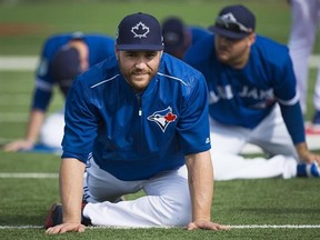 Toronto Blue Jays catcher Russell Martin stretches during baseball spring training in Dunedin, Fla., on Wednesday, February 15, 2017. When Martin decided to take up swimming as an off-season workout option a year ago, he was amazed at how quickly he progressed in the pool.It didn&#039;t hurt that his coach and training partner was a nine-time Paralympic gold medallist. THE CANADIAN PRESS/Nathan Denette