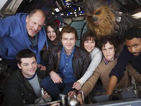 In this undated image provided by Lucasfilm, cast members and co-directors of the Han Solo &ampquot;Star Wars&ampquot; spin-off pose for a photo, from bottom left, co-director Christopher Miller, Woody Harrelson, Phoebe Waller-Bridge, Alden Ehrenreich, Emilia Clarke, Joonas Suotamo as Chewbacca, co-director Phil Lord and Donald Glover. The Walt Disney Co. announced Tuesday, Feb. 21, 2017, that shooting began at London&#039;s Pinewood Studios on Monday. (Jonathan Olley/Lucasfilm via AP)