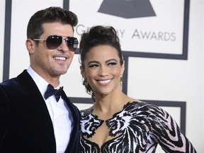 FILE - This Jan. 26, 2014 file photo shows Robin Thicke, left, and Paula Patton at the 56th annual Grammy Awards in Los Angeles. In a Feb. 21, 2017, court filing, Patton&#039;s attorneys accused Thicke of evidence tampering by altering a court order in an attempt to get the actress arrested for kidnapping in an ongoing custody dispute between the former couple. The filing was released Thursday, Feb. 23, one day before a trial on allegations that Thicke abused her and their 6-year-old son is scheduled