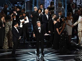 Actor Warren Beatty (C) explains a presentation error which resulted in Best Picture being announced as 'La La Land' instead of 'Moonlight' onstage during the 89th Annual Academy Awards at Hollywood & Highland Center on February 26, 2017 in Hollywood, California.