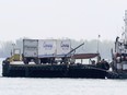 An international truck ferry carries trucks across the Detroit River to Canada on May 8, 2013.