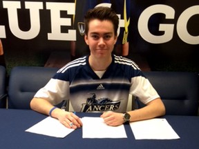 Chris Campbell signs his commitment to play soccer with the University of Windsor next season.