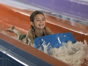 Dallas Payne, 5, takes a ride down the Whizzard at Adventure Bay Family Water Park as families filled the park celebrating Family Day on Feb. 20, 2017.