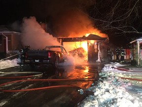 Leamington fire crews battle a garage and vehicle fire on Jane Street in Leamington on Feb. 1, 2017.
