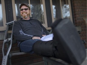 Ward 4 councillor Chris Holt won't let a broken leg keep him from his civic duties. Here he sits on his porch on Feb. 20, 2017, sporting a leg cast looking over some notes.