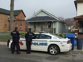 Windsor police officers continue to watch over the crime scene at 760 University Ave. East on Feb. 22, 2017. The night before, a 19-year-old male died from a gunshot wound believed to be inflicted at the address. A 45-year-old male suspect has been arrested.