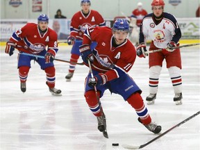 Lakeshore Canadiens J.J. Percy, centre, carries the puck against the Petrolia Flyers in Provincial Junior Hockey League playoff action at Atlas Tube Centre February 7, 2017.