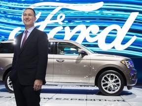 Ford Canada president Mark Buzzell poses in front of the 2017 Ford Expedition during the Canadian International Auto Show,in Toronto on Feb. 16, 2017.
