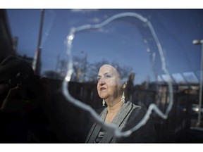 Mazal (who did not want her last name published), owner of Mazal Tov Kosher Cuisine, looks out the smashed window of her restaurant, Feb. 3,  2017.  Someone threw a large rock through the window.