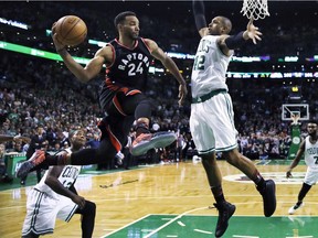 Toronto Raptors guard Norman Powell (24) looks to pass as Boston Celtics centre Al Horford (42) attempts a block during the second half of an NBA basketball game in Boston, Wednesday, Feb. 1, 2017. The Celtics defeated the Raptors 109-104.