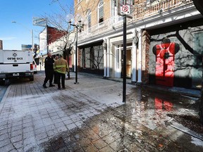 Investigators with the Ontario Fire Marshal's office and Windsor Fire & Rescue Services stand outside the former Pour House Pub (52 Chatham St. West) on Feb. 13, 2017.