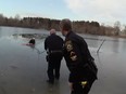 John O'Rourke is pulled from the icy waters of Mondo Pond by local police after saving a boy who fell through the ice.