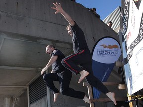 Windsor Police Service media relations officers Sgt. Steve Betteridge, left, and Const. Andy Drouillard dive in during the annual Polar Plunge at the St. Clair College in Windsor on Feb. 2, 2017.