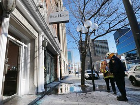 Investigators from the Ontario Fire Marshal's office and Windsor Fire & Rescue Services examine the property at 52 Chatham St. West - the former Pour House Pub - in downtown Windsor on Feb. 13, 2017.