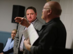 Essex MPP Taras Natyshak listens as OPSEU regional vice-president Len Elliott speaks at a meeting protesting the closure of the ServiceOntario office in Belle River on Feb. 18, 2017.