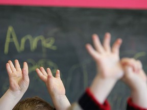 Children wave their hands at a school.