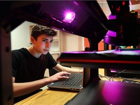 Thirteen-year-old Mitchell Myers, a Grade 8 student at St. William Catholic Elementary School in Lakeshore, keeps an eye on a 3-D printer at the school's innovation centre on Monday.