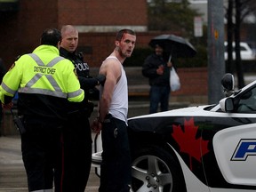 Windsor police place a man into custody after he slammed a stolen vehicle into the side of Tim Hortons at Goyeau Street and Park Street East on Feb. 7, 2017.