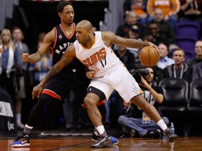 P.J. Tucker #17 of the Phoenix Suns handles the ball against DeMar DeRozan #10 of the Toronto Raptors during the first half of the NBA game at Talking Stick Resort Arena on Feb. 2, 2016 in Phoenix, Arizona. Reports indicate Tucker has been traded to Toronto.