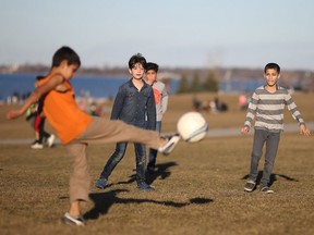 Boys play a game of soccer at Great Western Park along Windsor's riverfront during record-breaking spring-like temperatures, Saturday, Feb. 18, 2017.