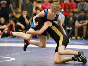Holy Names' Logan Renaud, left, and L'Essor Mateo Chariro battle during the WECSSAA high school wresting championships at the Tecumseh Vista Academy on Wednesday, Feb. 8, 2017.