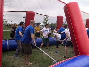 Windsor Corporate Challenge teams from Valiant and KM&T compete in a human foosball game on June 20, 2015.