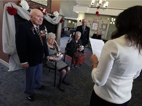 John and Doris Kubis, left, and Bernard and Sheila Marontate renew their wedding vows with the help of Jacinta Colasanti on Valentine's Day at Chartwell Kingsville Retirement Residence in Kingsville on Feb. 14, 2017.