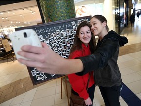 Sisters Courtney, left, and Cassidy Wood snap a selfie during the Be Your Selfie event at Devonshire Mall on Sunday, Feb. 5, 2017.